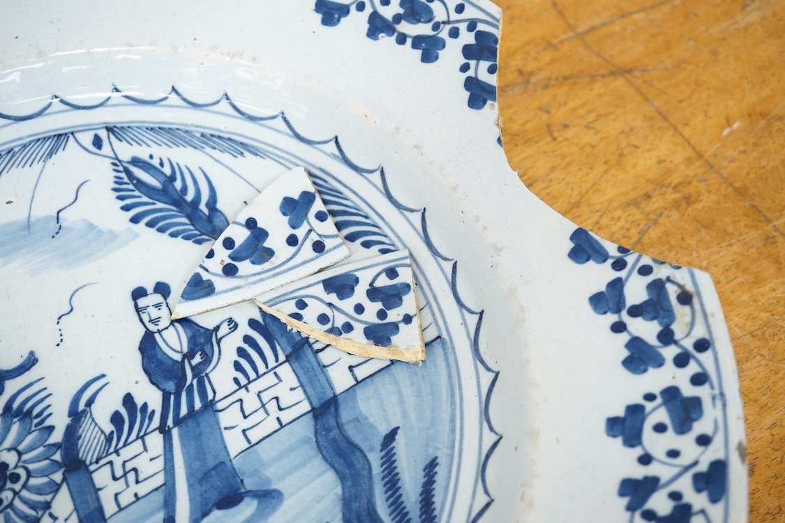 An 18th century English delftware ‘Chinese figures’ dish and two similar Delft dishes, largest 39cm diameter (3), largest 39cm